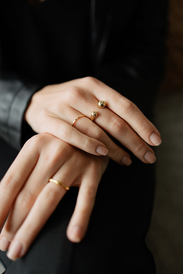 Sophie adjustable ring in 18k gold plated brass with modern open design on dark background