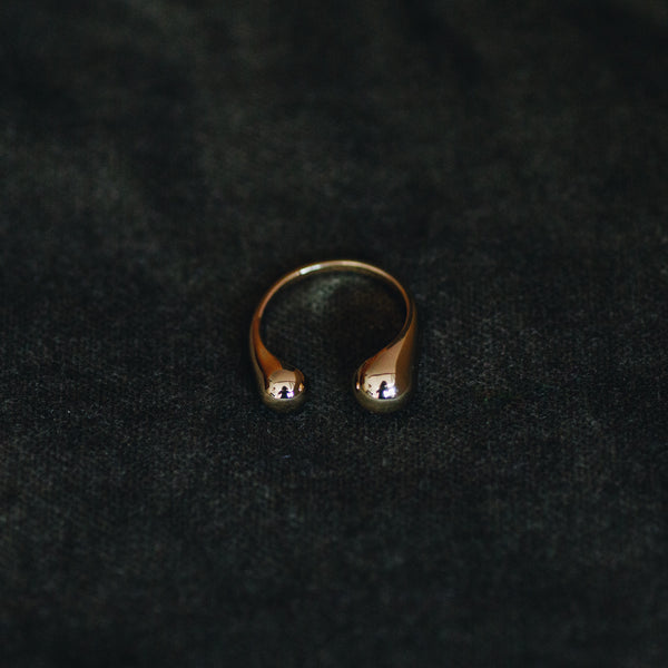 Sophie adjustable ring in 18k gold plated brass with modern open design on dark background