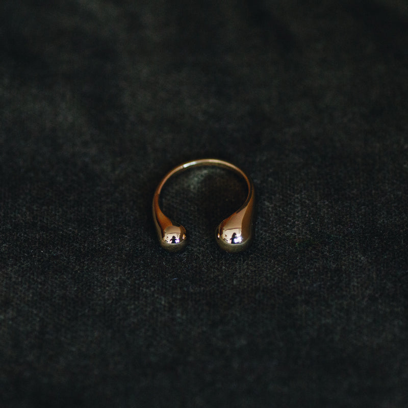 Sophie adjustable ring in 18k gold plated brass with modern open design on dark background