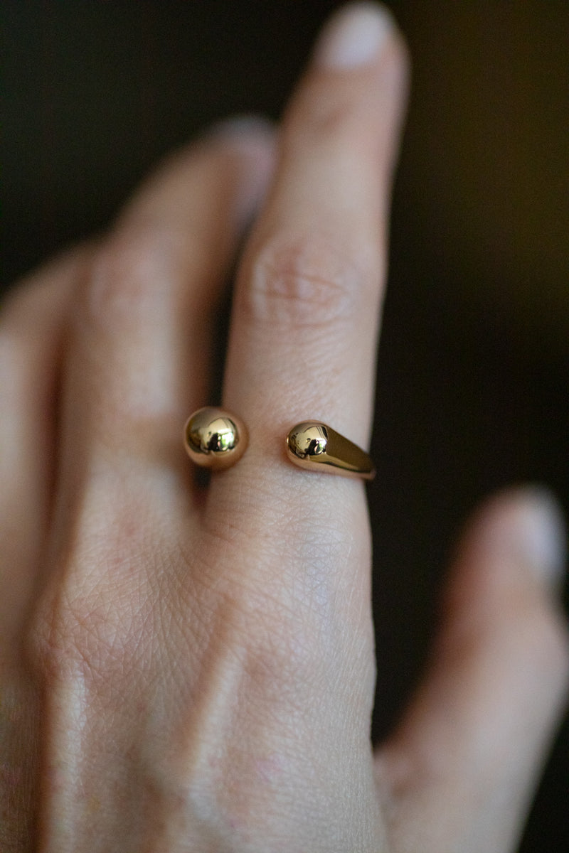 Sophie adjustable ring in 18k gold plated brass with modern open design on dark background