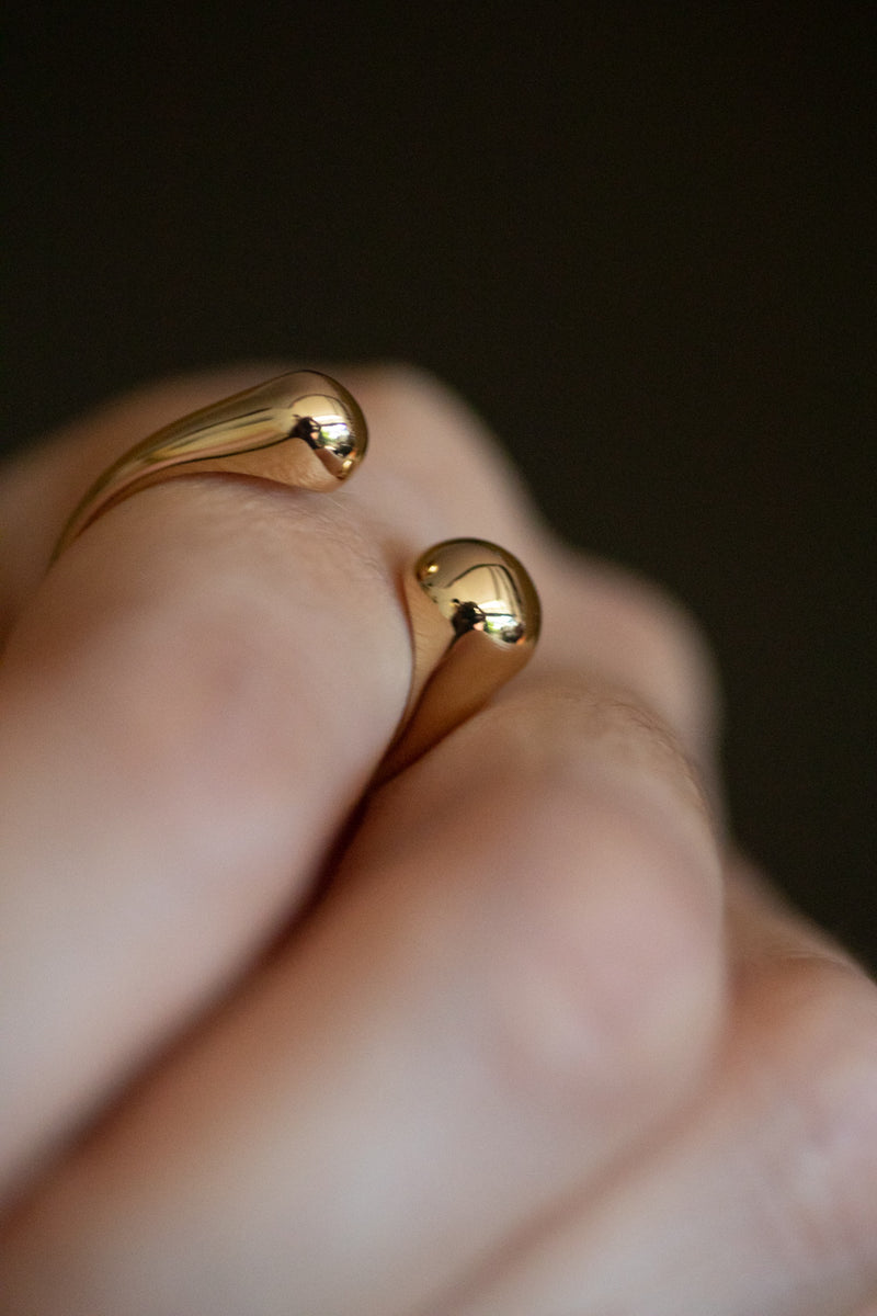 Sophie adjustable ring in 18k gold plated brass with modern open design on dark background