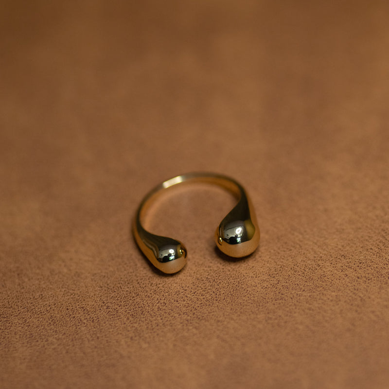 Sophie adjustable ring in 18k gold plated brass with modern open design on dark background